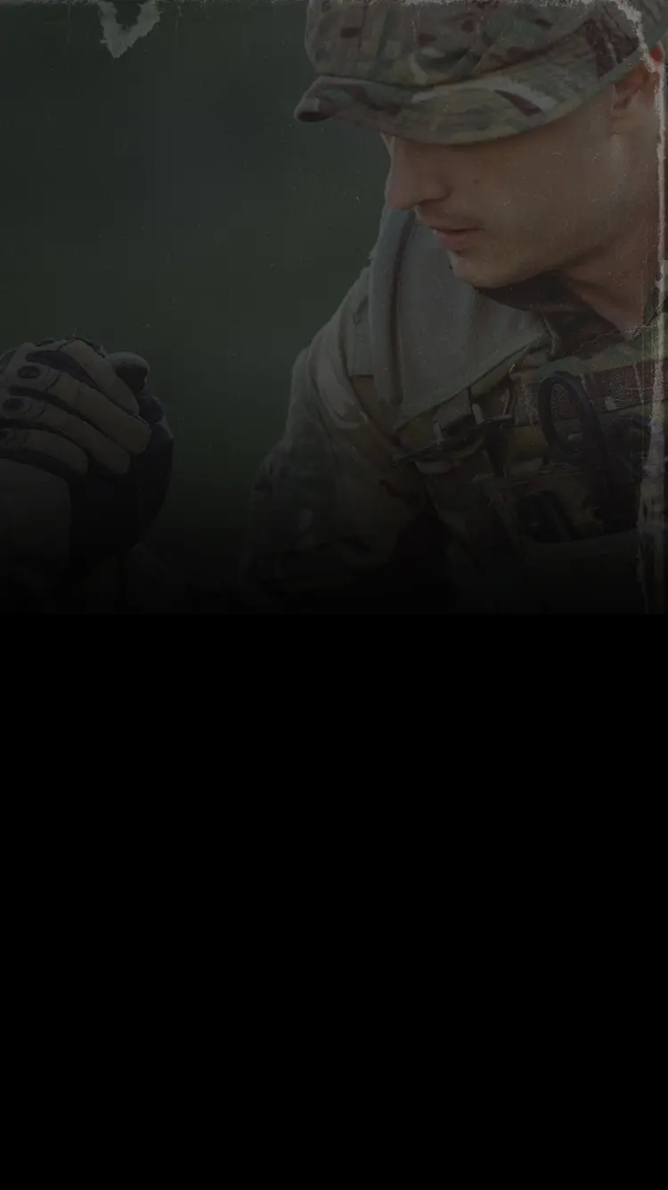 Soldier helping a fellow soldier up